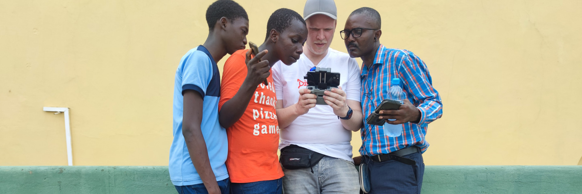 A DroneMasters Academy trainer shows African students how to control a drone