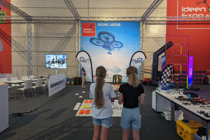 Zwei Mädchen bestaunen den Messestand der DroneMasters Academy